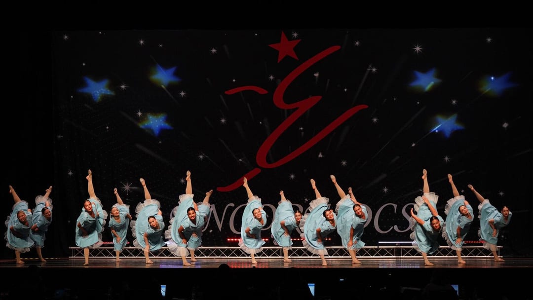 Competition Team dancers posed together on stage